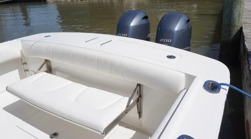 Slide: The Image of 2015 Regulator 25 boat with twin 200 engines, docked by the water. - 12