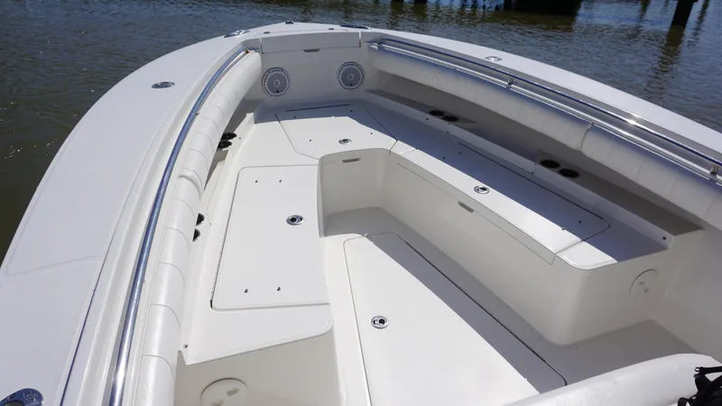 Slide: The Image of 2015 Regulator 25 boat interior with spacious seating and storage compartments. - 13