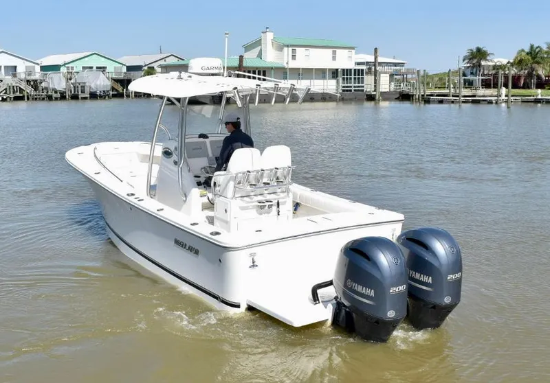 Slide: The Image of 2015 Regulator 25 boat with dual Yamaha engines on calm water. - 3