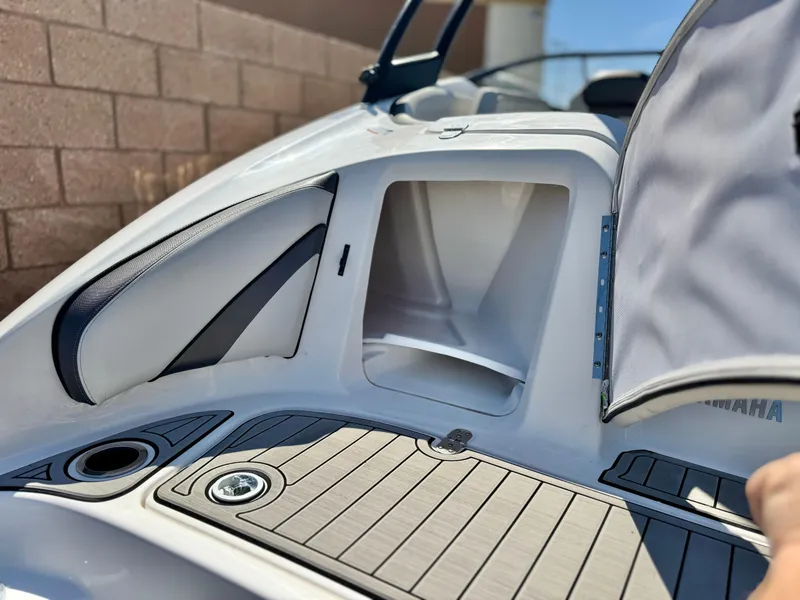 Slide: The Image of 2020 Yamaha AR240 boat storage compartment with open hatch, showcasing sleek design and functionality. - 10