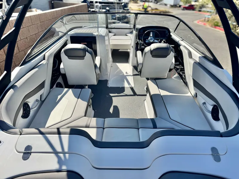 Slide: The Image of 2020 Yamaha Boats AR240 interior with sleek seating and modern dashboard design. - 18