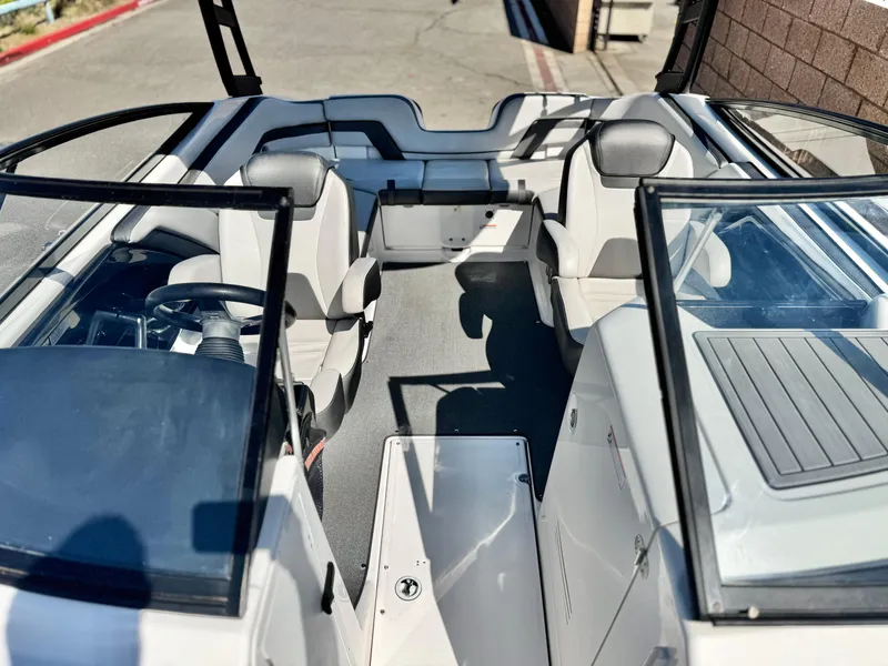 Slide: The Image of 2020 Yamaha Boats AR240 interior with seating and steering wheel, showcasing modern design. - 19