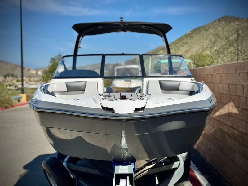 Slide: The Image of 2020 Yamaha Boats AR240 on trailer, parked outdoors with scenic background. - 2