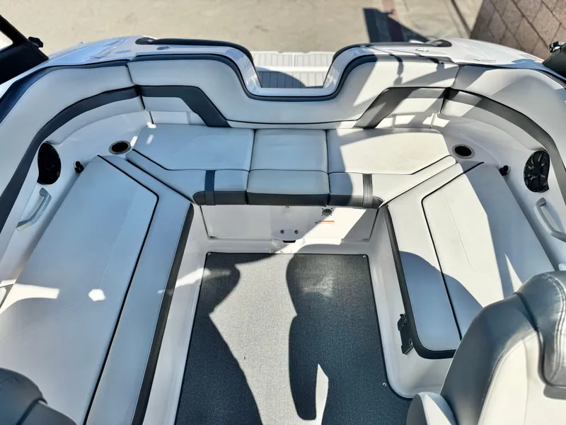 Slide: The Image of 2020 Yamaha Boats AR240 interior seating with gray and white upholstery. - 20