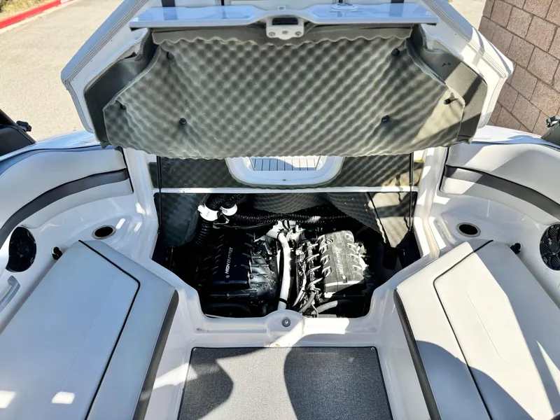 Slide: The Image of 2020 Yamaha Boats AR240 engine compartment with open hatch, showcasing interior details and seating. - 24
