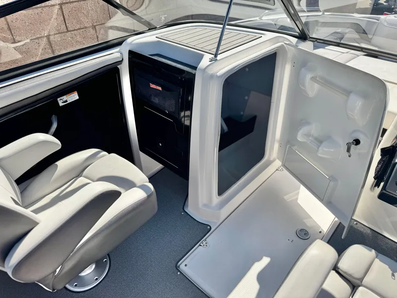 Slide: The Image of 2020 Yamaha Boats AR240 interior with helm seat and storage area. - 27