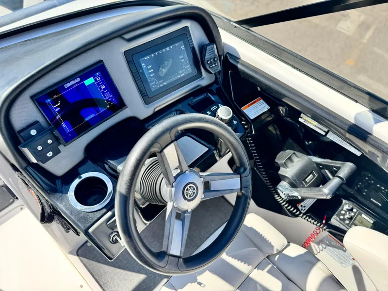 Slide: The Image of 2020 Yamaha AR240 boat dashboard with steering wheel, digital displays, and controls. - 32