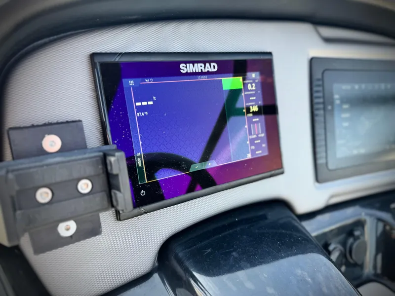 Slide: The Image of Simrad display on 2020 Yamaha AR240 boat dashboard, showing navigation data. - 33