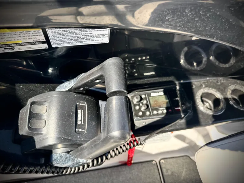 Slide: The Image of Yamaha Boats AR240 2020 dashboard with controls and cup holders. - 40