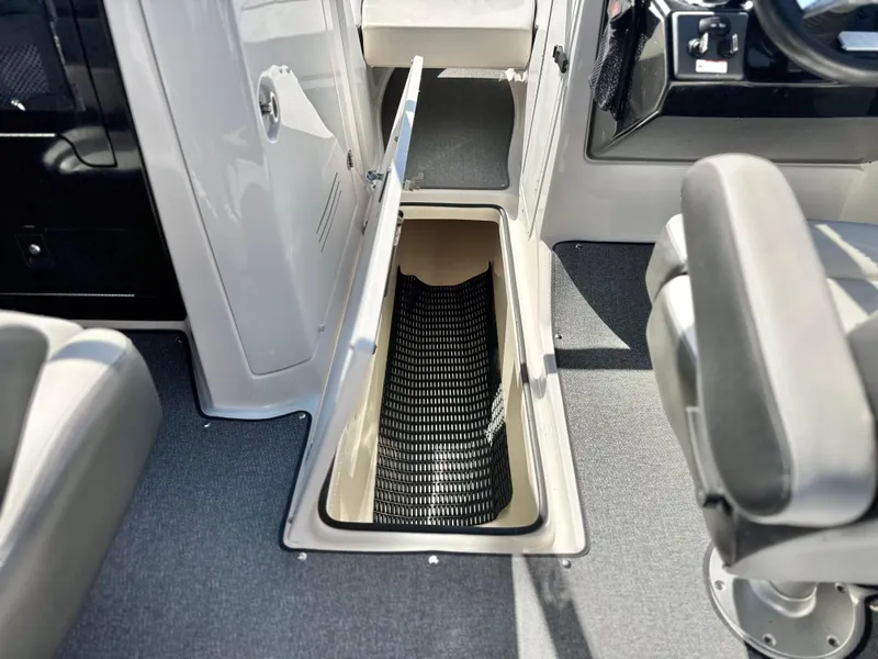 Slide: The Image of 2020 Yamaha AR240 boat interior storage compartment with open hatch and seating. - 42