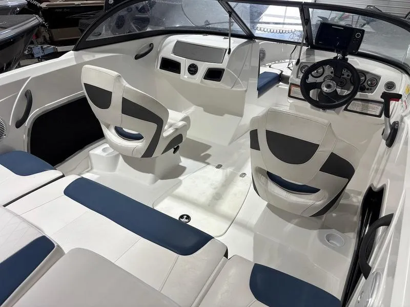 Slide: The Image of Interior of a 2020 Tahoe 450 TF boat with white and blue seating. - 5