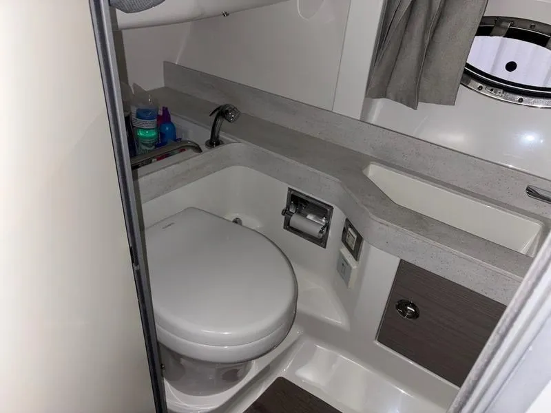 Slide: The Image of 2019 Formula 350 Crossover Bowrider bathroom with toilet and sink. - 13