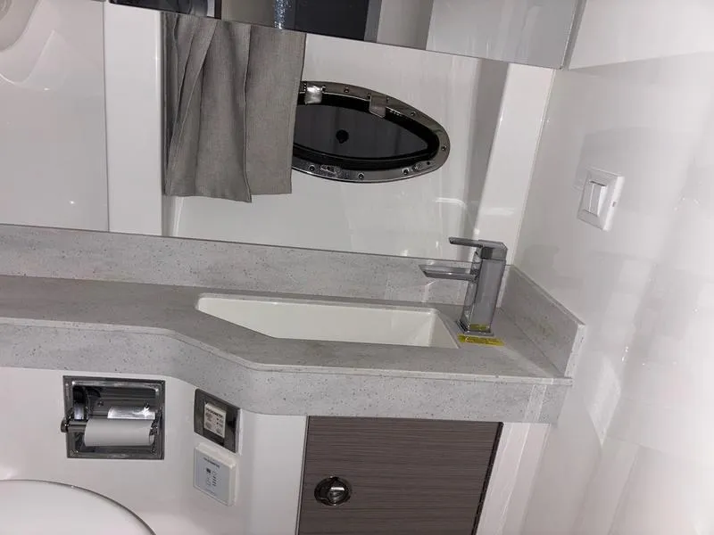 Slide: The Image of Modern bathroom in 2019 Formula 350 Crossover Bowrider with sleek sink and porthole window. - 15