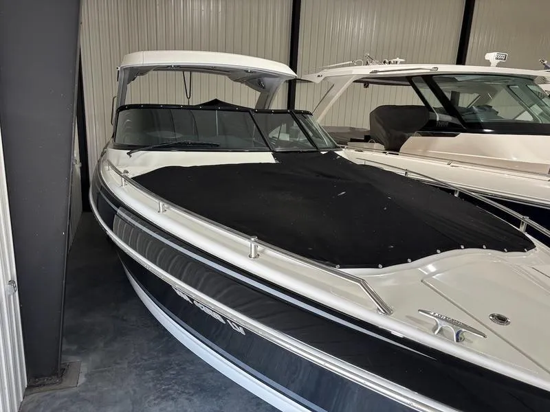 Slide: The Image of 2019 Formula 350 Crossover Bowrider in storage, black and white exterior. - 2