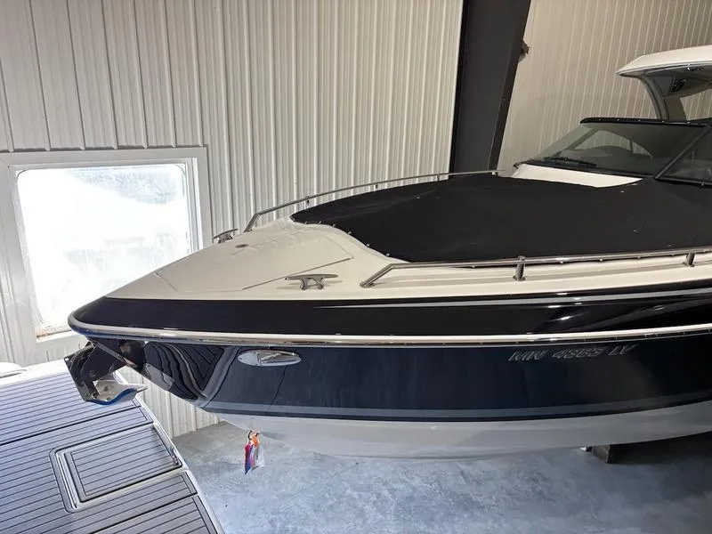 Slide: The Image of 2019 Formula 350 Crossover Bowrider in storage, black and white exterior, covered bow. - 5