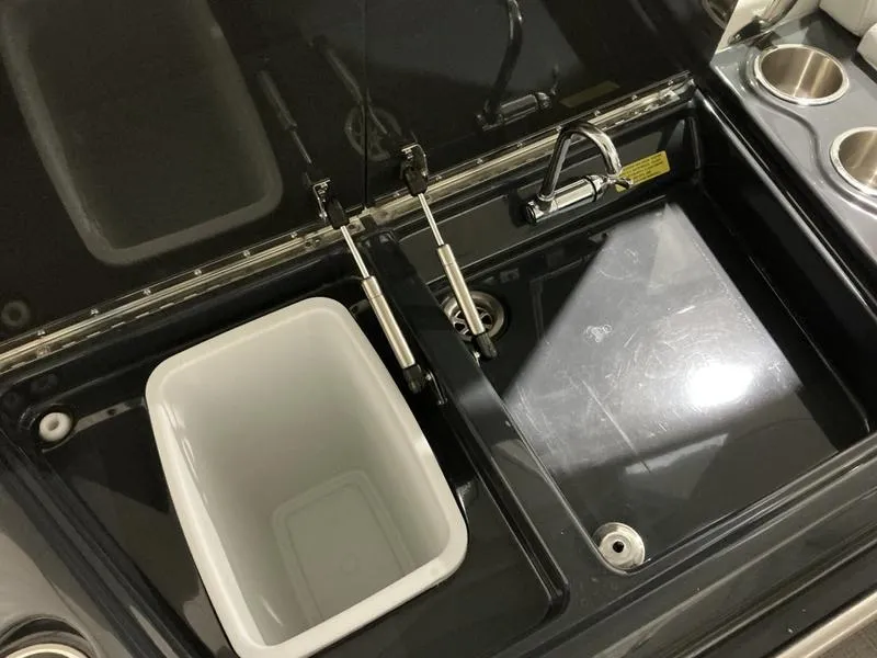 Slide: The Image of 2019 Formula 350 Crossover Bowrider sink and storage area with cup holders. - 9
