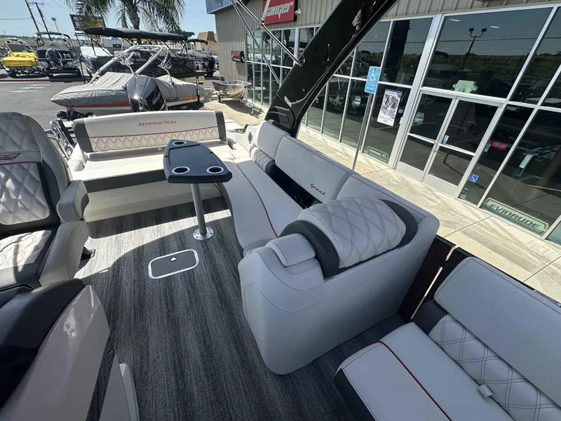 Slide: The Image of Luxurious interior of 2025 Bennington 25 RXSB pontoon boat with plush seating and table. - 11