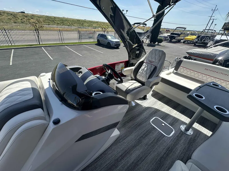 Slide: The Image of Interior of 2025 Bennington 25 RXSB boat with modern seating and steering console. - 12