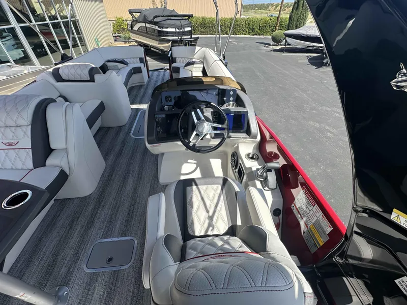 Slide: The Image of 2025 Bennington 25 RXSB boat interior with luxurious seating and modern dashboard. - 15