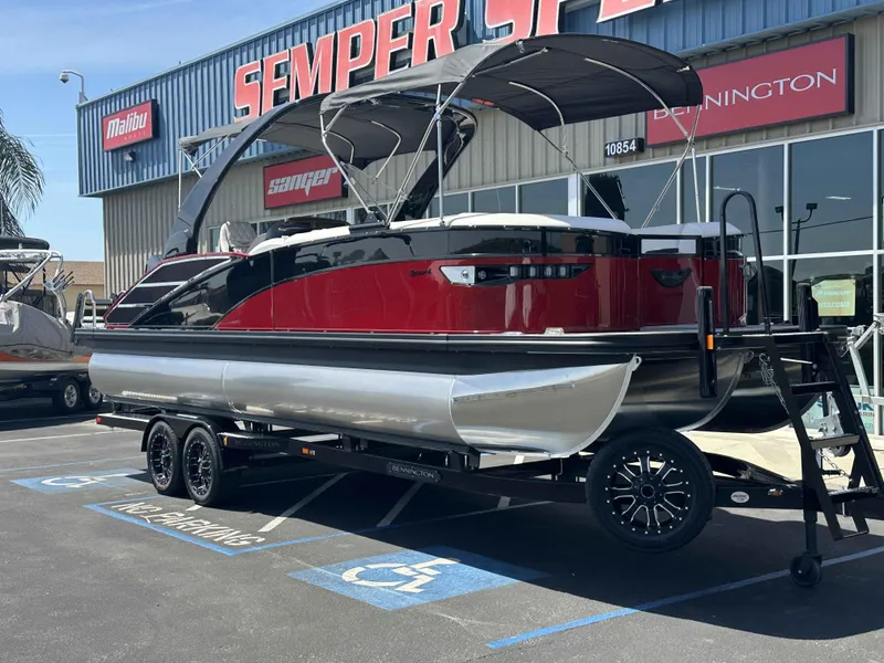 Slide: The Image of 2025 Bennington 25 RXSB pontoon boat on trailer at dealership. - 2