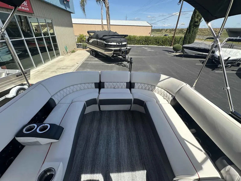 Slide: The Image of 2025 Bennington 25 RXSB pontoon boat interior with luxurious seating and cup holders. - 20