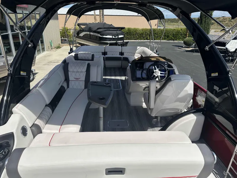 Slide: The Image of 2025 Bennington 25 RXSB pontoon boat interior with luxurious seating and modern helm. - 22