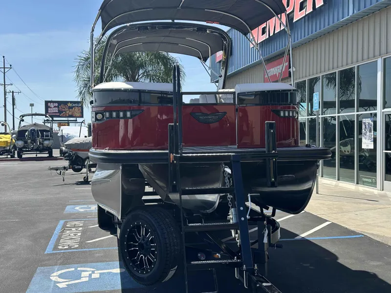 Slide: The Image of 2025 Bennington 25 RXSB pontoon boat on trailer at dealership, sunny day. - 3