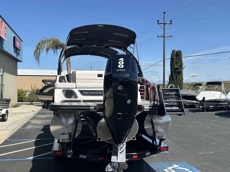 Slide: The Image of 2025 Bennington 25 RXSB boat with Mercury 400 V10 engine in a parking lot. - 6