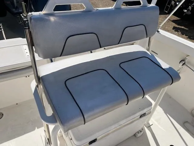Slide: The Image of 2019 Wellcraft 18 CC boat seating with storage underneath, featuring cushioned bench design. - 11