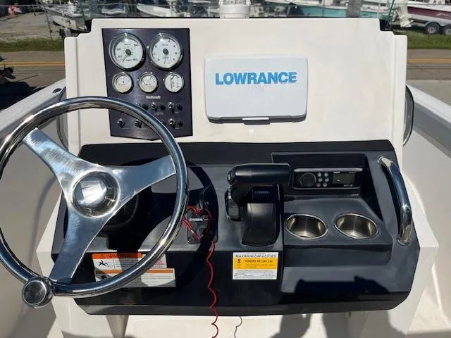 Slide: The Image of 2019 Wellcraft 18 CC boat dashboard with steering wheel, gauges, and Lowrance navigation system. - 8
