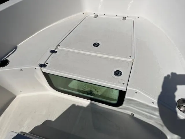 Slide: The Image of 2019 Wellcraft 18 CC boat interior with storage compartment and clean white finish. - 9