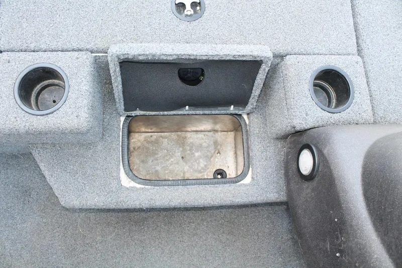 Slide: The Image of 2022 Tracker Pro Team 190 TX boat interior with storage compartment and cup holders. - 11