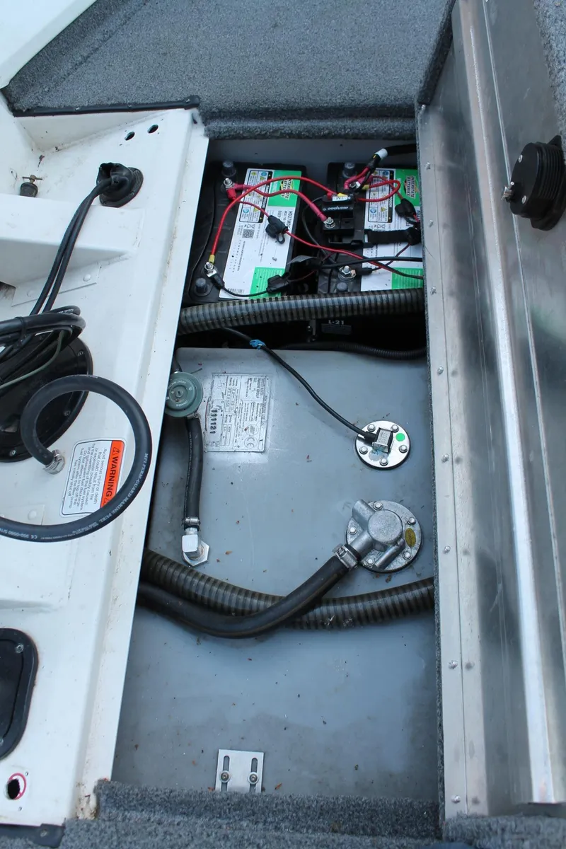 Slide: The Image of 2022 Tracker Pro Team 190 TX boat battery compartment with wiring and components. - 15