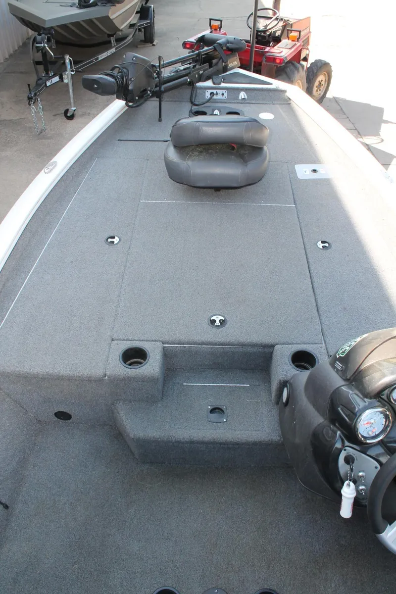 Slide: The Image of 2022 Tracker Pro Team 190 TX boat interior with seating and motor, ideal for fishing. - 20