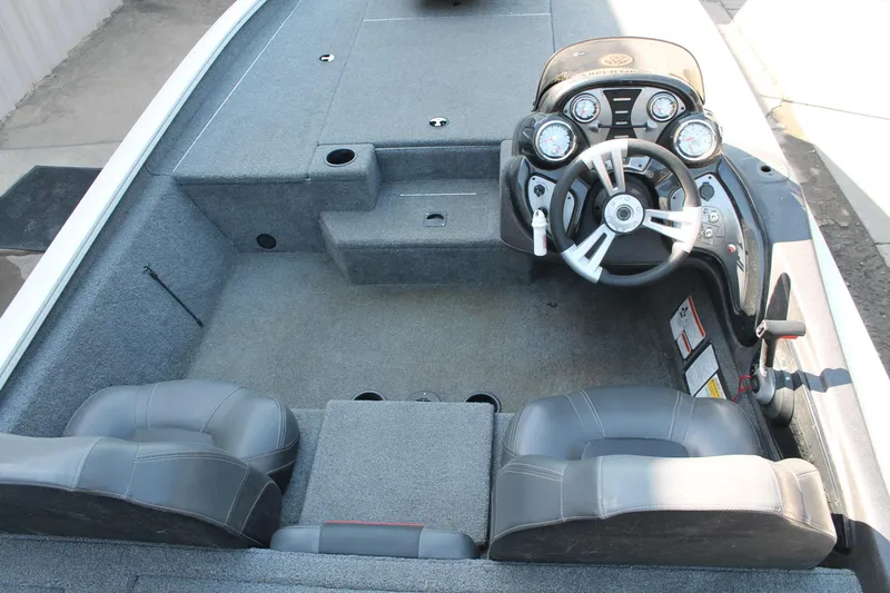 Slide: The Image of 2022 Tracker Pro Team 190 TX boat interior with steering console and seating. - 5