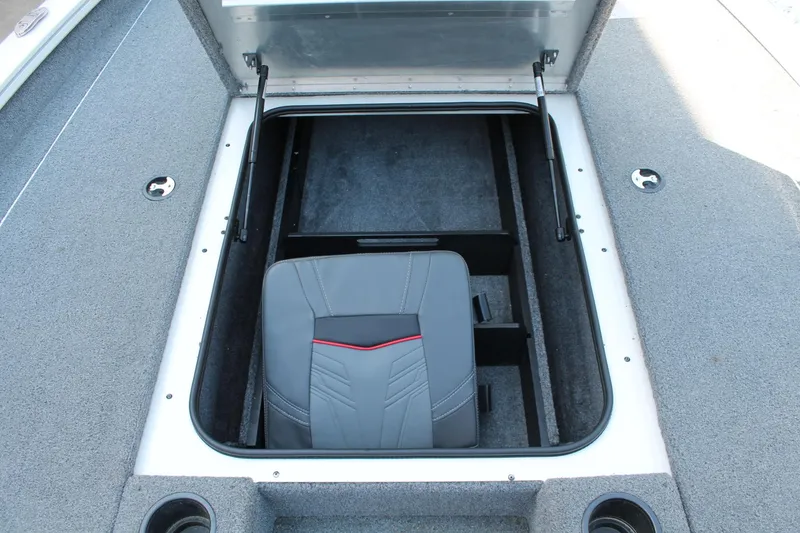 Slide: The Image of 2022 Tracker Pro Team 190 TX boat storage compartment with seat inside. - 9