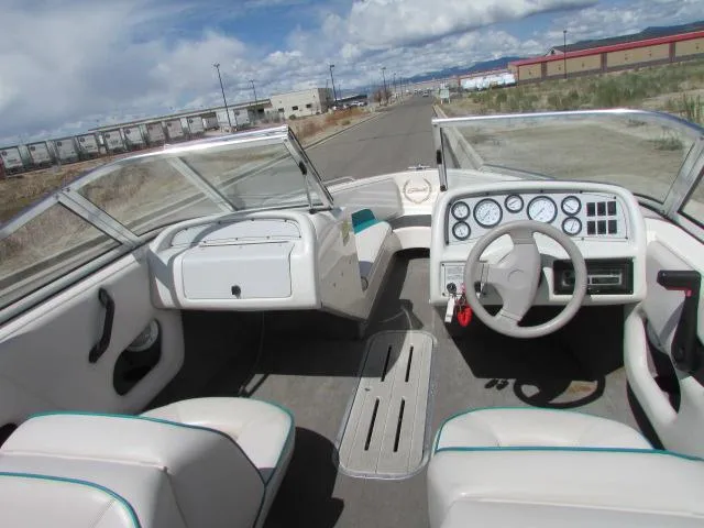 Slide: The Image of 1995 Seaswirl 180 boat interior with steering wheel and dashboard, parked on a road. - 4