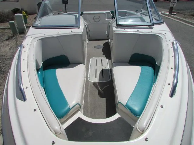 Slide: The Image of 1995 Seaswirl 180 boat interior with teal and white seating, open bow design. - 5