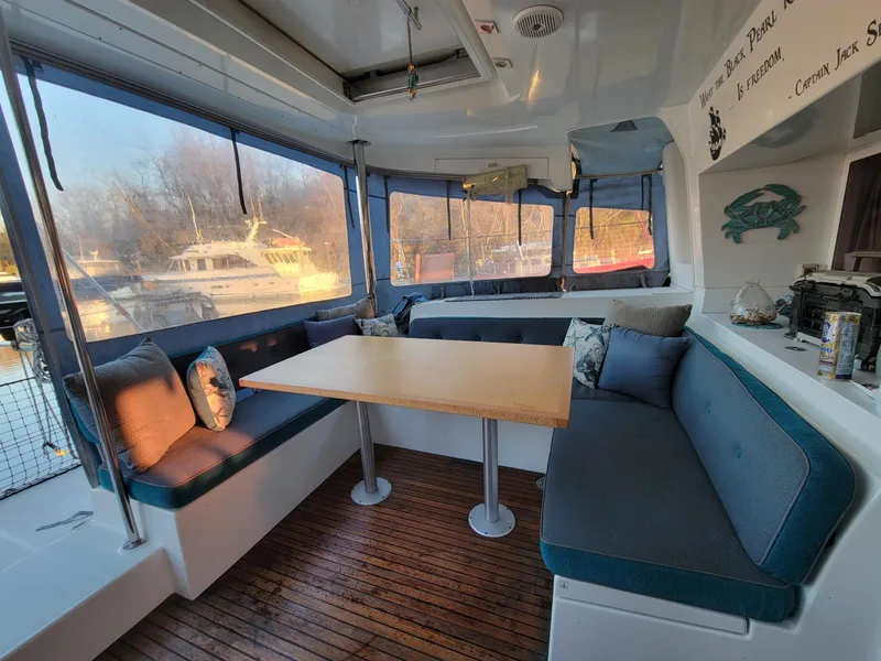 Slide: The Image of Spacious interior of 2011 Lagoon 450 catamaran with cozy seating and wooden flooring. - 1