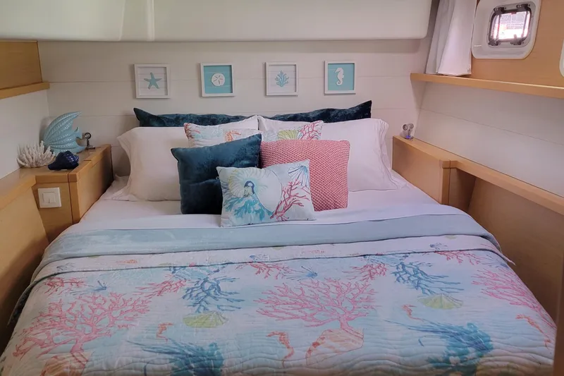 Slide: The Image of Cozy bedroom in 2011 Lagoon 450 yacht with nautical-themed decor and colorful bedding. - 10