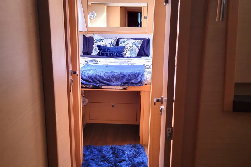 Slide: The Image of Luxurious cabin interior of 2011 Lagoon 450 yacht with cozy bedding and blue accents. - 11