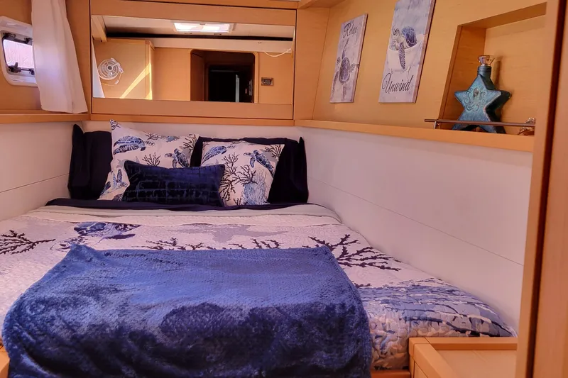 Slide: The Image of Cozy bedroom in 2011 Lagoon 450 yacht with nautical-themed decor and blue accents. - 12