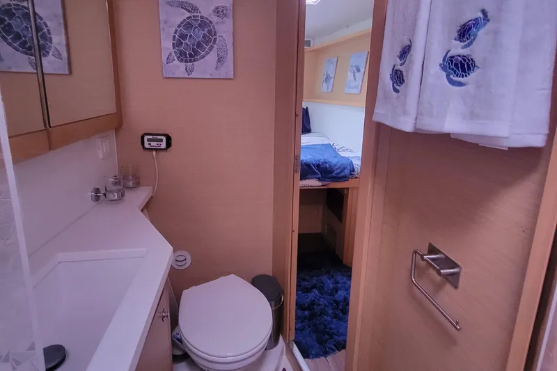 Slide: The Image of Bathroom and bedroom interior of 2011 Lagoon 450 yacht, featuring nautical decor. - 13