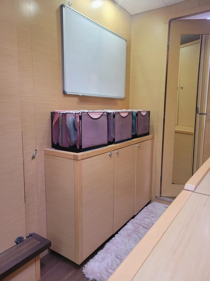 Slide: The Image of Interior of 2011 Lagoon 450 yacht with storage cabinet and decorative bins. - 18