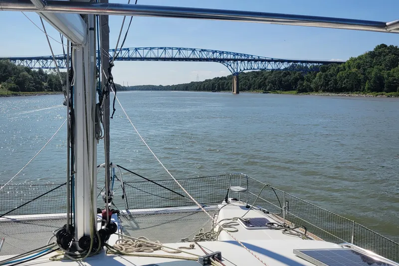 Slide: The Image of Lagoon 450 catamaran sailing under a bridge on a sunny day, 2011 model. - 27