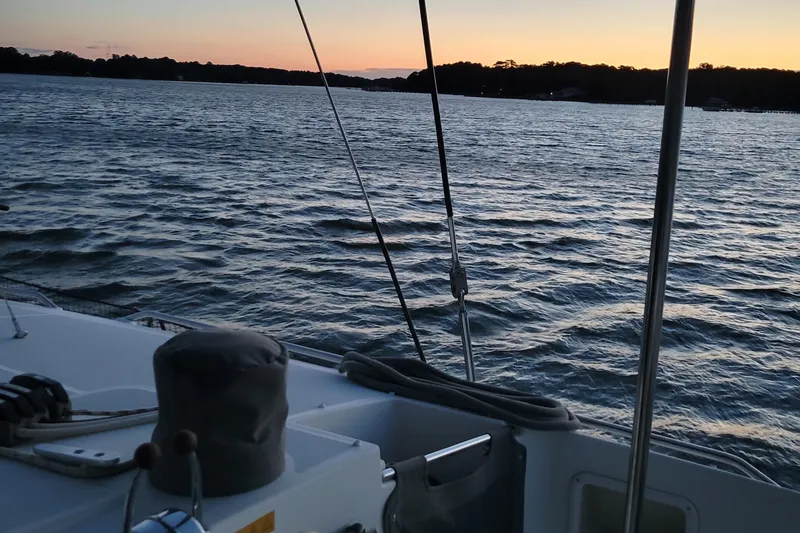 Slide: The Image of Lagoon 450 catamaran sailing at sunset on calm waters, 2011 model. - 29