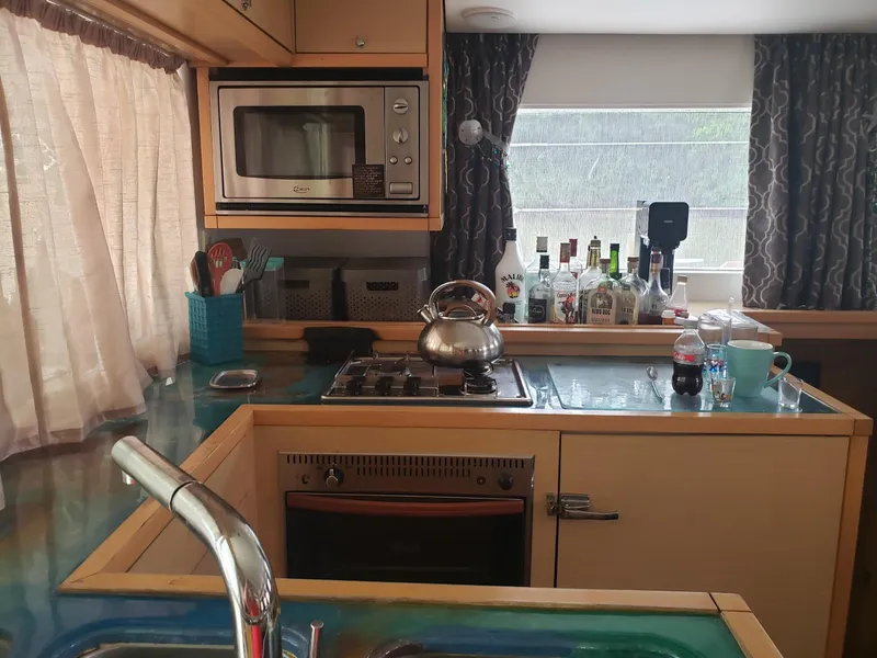 Slide: The Image of Kitchen interior of 2011 Lagoon 450 yacht with appliances and countertop items. - 3