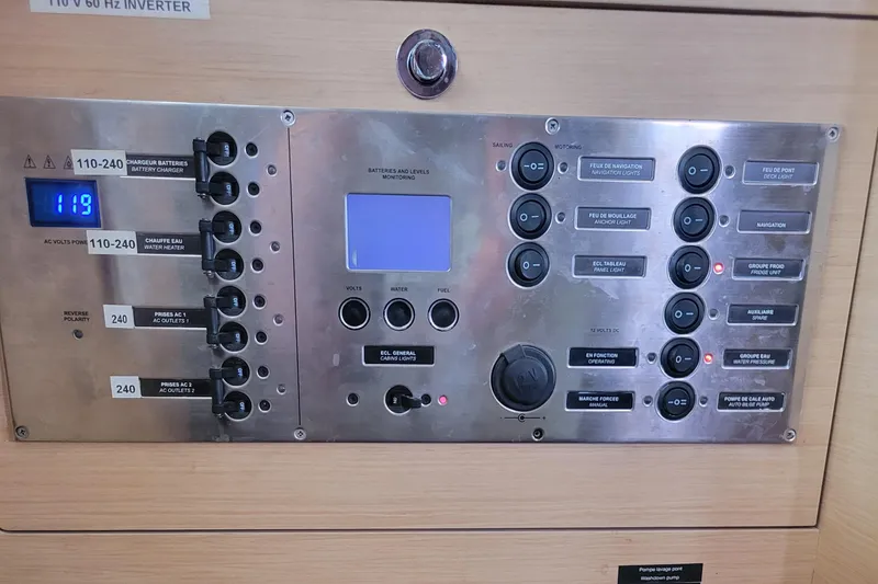 Slide: The Image of Control panel of a 2011 Lagoon 450 yacht, featuring switches and digital display. - 42