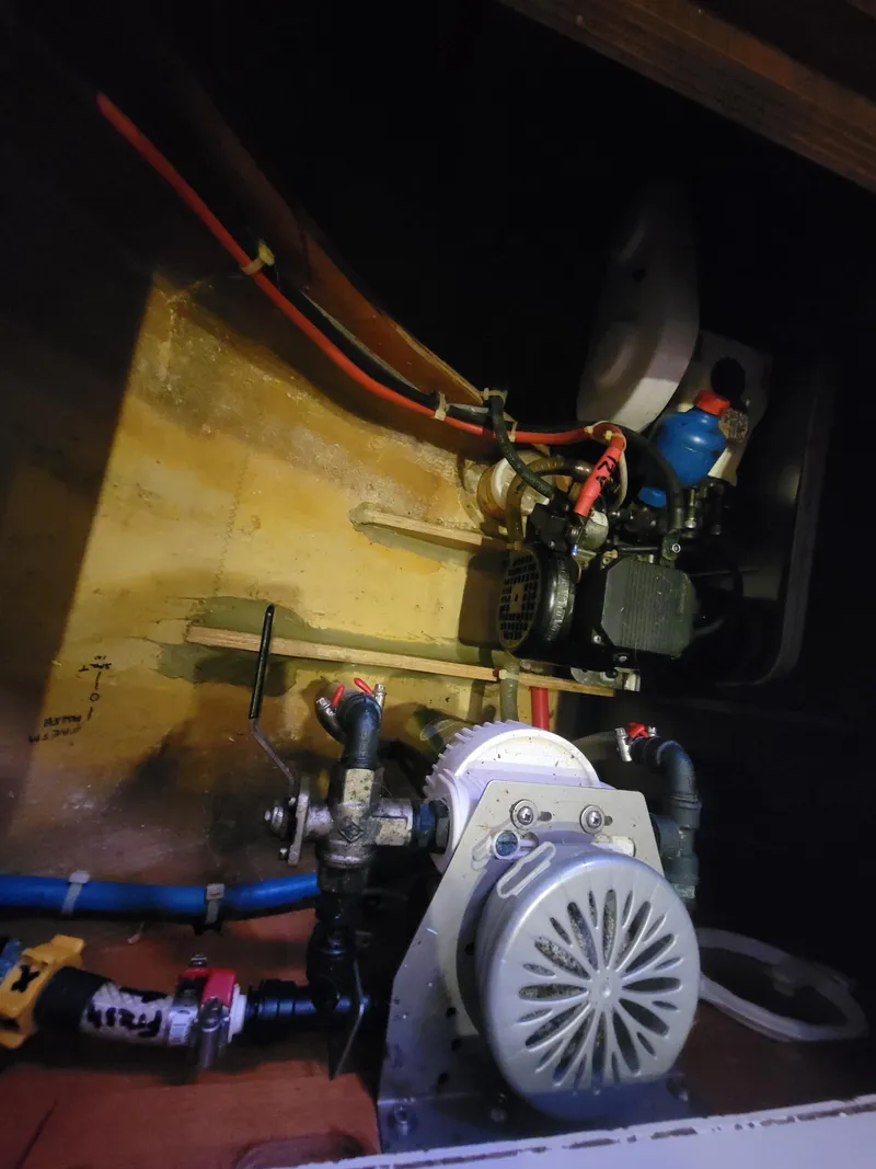 Slide: The Image of Engine compartment of a 2011 Lagoon 450 catamaran, showcasing mechanical components and wiring. - 44