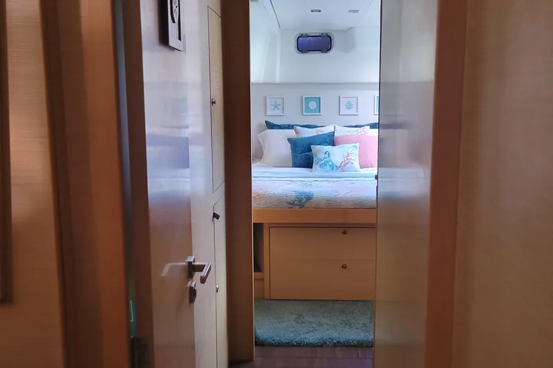 Slide: The Image of Cozy bedroom interior of 2011 Lagoon 450 yacht with plush bedding and decorative pillows. - 9